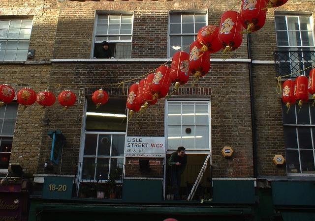 Staff at See Woo supermarket take part in festivities from the upper floors 