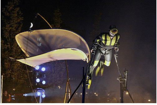 An acrobat dressed as a diver attempts to out-run a wave as part of Dutch theatre group Close Act's performance, Pi-leau by MykReeve 