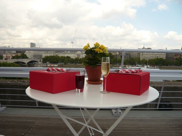 Picnic boxes and champagne, view of London behind. Photo by W P Wiles 