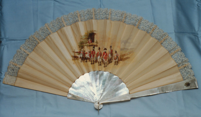 Mother-of-pearl fan with silk leaf edged in lace painted by R. Wymer with a group of Coldstream Guards at rest. English, late 19th century 