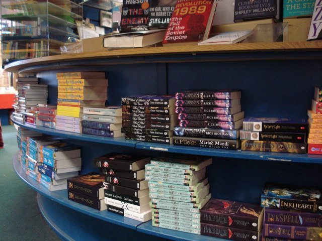 Piles of books by the tills 