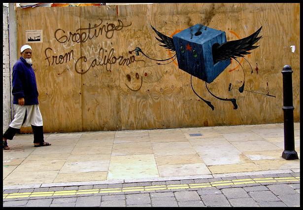 An elderly Bangla gentleman disapproves of me in Brick Lane. He's unaware though that by walking into my frame, he's creating a ludicrous juxtaposition - subversive street art welcoming one to California, in the middle of ethnic London, mirrored in colour by a conservative Muslim gentleman.
