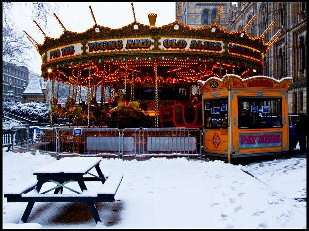 "For The Young And Old Alike": a carousel in front of the Natural History Museum stands out in brilliant contrast against the snow.