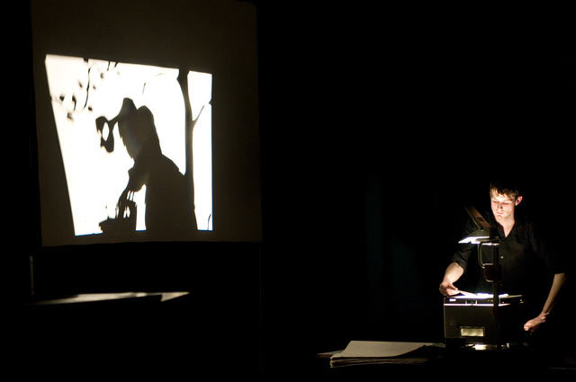 The shadowpuppetry of Matthew Robins' 'Death of Flyboy'. Matthew Robins and band are out of shot on the left.  Alex Muller