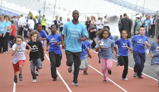 Michael Johnson resisting the urge to beat small children at the 100m