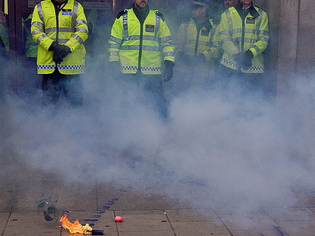 A burning missile thrown towards police outside TopShop / chrisjohnbeckett from the Londonist Flickr pool