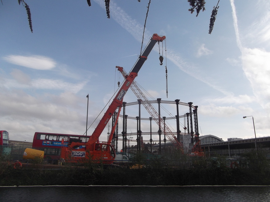 A mass of cranes and steel, from the canal towpath.