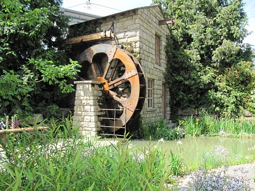 Water wheel and house in the HESCO Garden, which celebrates Leeds and water power