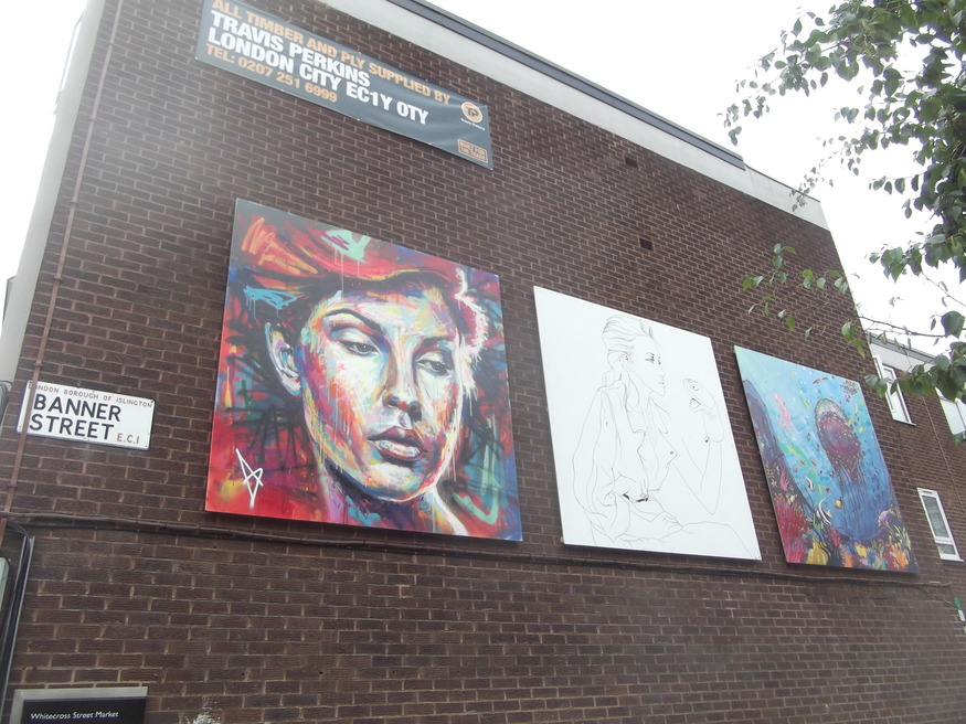 Panels of artwork line the street.