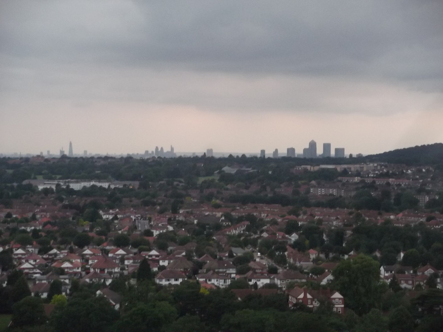 The far off city, with the Shard to the left, City at centre and Canary Wharf to the right. Shooters Hill looms to the extreme right.