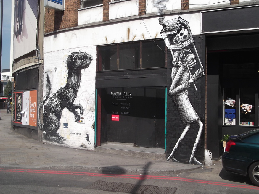 Phlegm's new piece (right) beside an old work by Roa.
