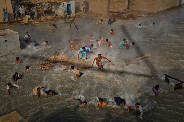 1st Prize People In The News Stories: Daniel Berehulak, Australia, Getty Images. Pakistan floods, August-September: Flood victims scramble for food as they battle the downwash from a Pakistan army helicopter during relief operations, Dadu, Pakistan, 13 September