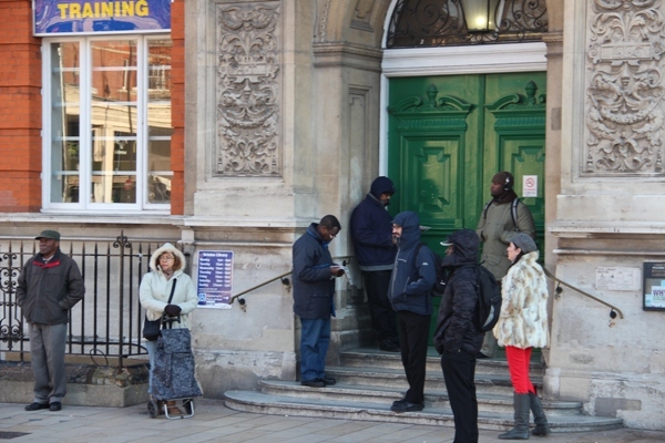 Huddled waiting for the library to open by Tim Woodall