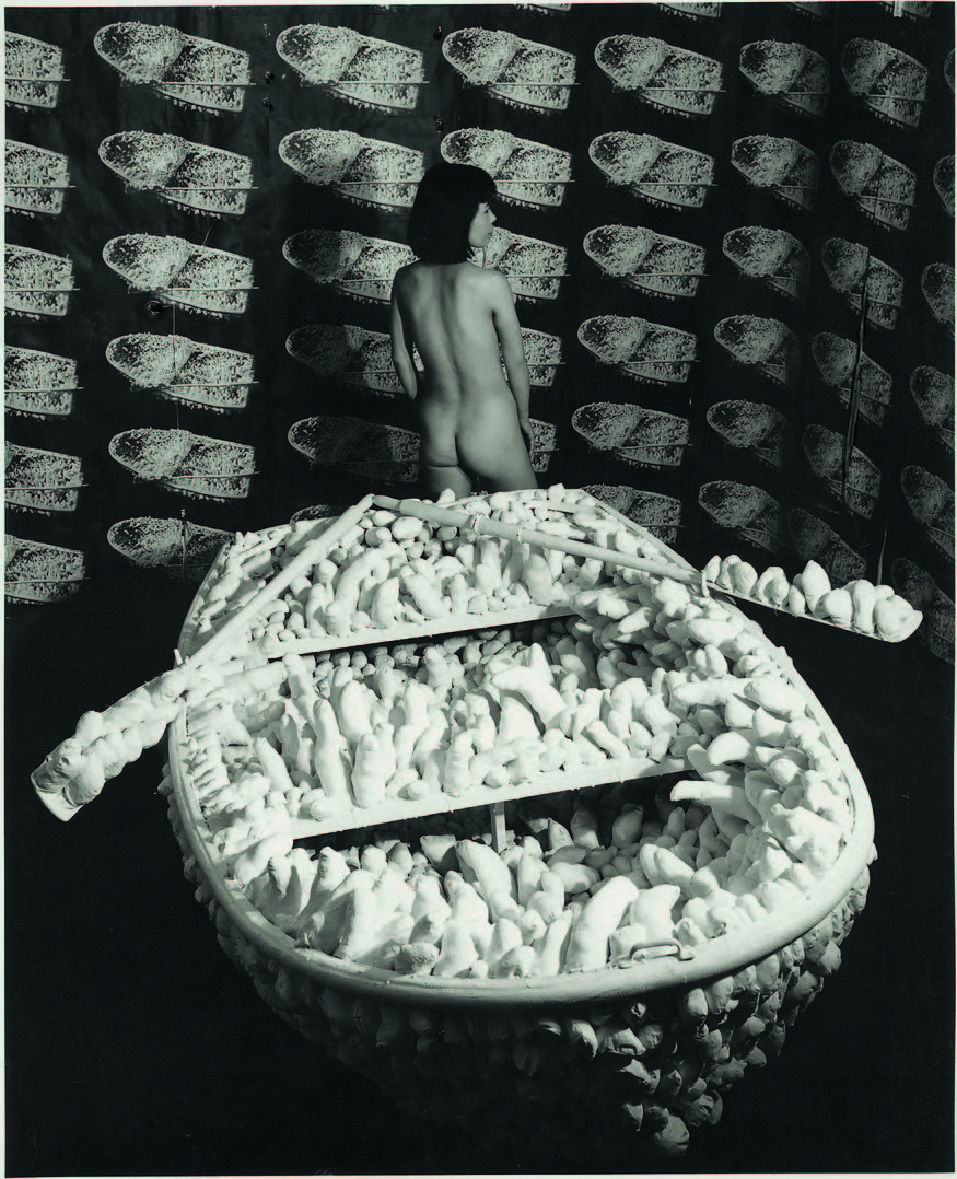 Kusama posing in Aggregation: One Thousand Boats Show 1963. Installation view, Gertrude Stein Gallery, New York. © Yayoi Kusama and © Yayoi Kusama Studios Inc