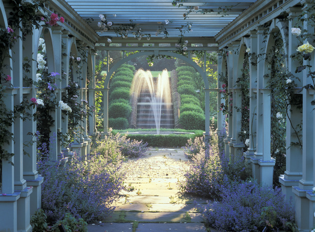 Mount Sharon garden in Orange, VA, designed by Charles Stick. The pergola and fountain in the rose garden are touched by shimmering afternoon light.