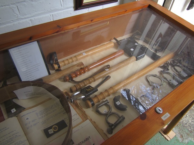 A selection of truncheons and cuffs.