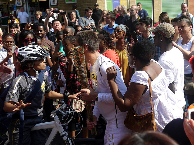 The next torch bearer gets his instructions amid huge excitement on Great Dover Street SE1 yesterday by Paul Wood