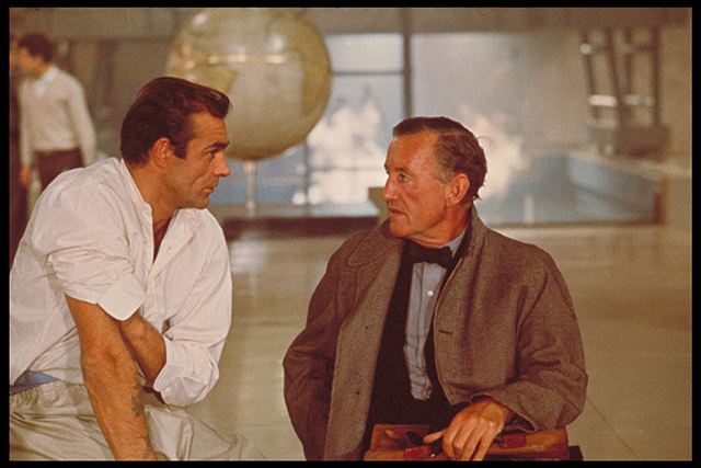 Sean Connery and author Ian Fleming discuss the character of James Bond while filming an interior scene for "Dr No" at Pinewood Studios. Copyright Notice - © 1962 Danjaq, LLC and United Artists Corporation. All rights reserved