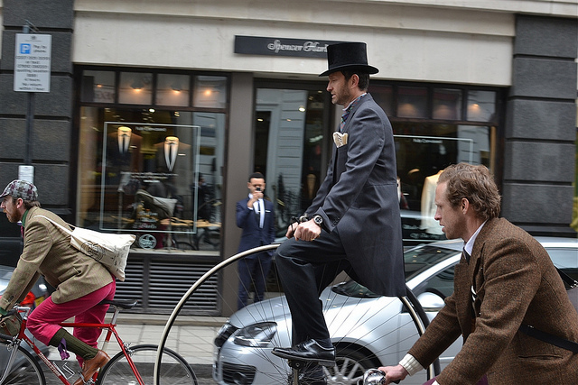 First sighting of a penny farthing out on the road. This time rolling past a tailors.