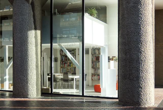 The ground floor unit in Shakespeare Tower. It originally opened as Butlers, a wine bar (the logo is still etched onto the glass). Later it became PInxtos, a tapas bar. It is now an architect's office. 