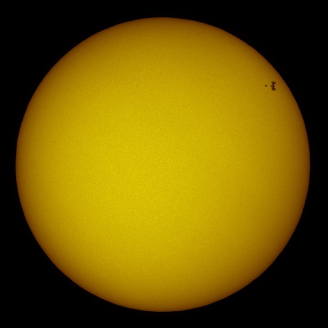 Look closely, and that sun spot isn't what it seems. Atlantis and International Space Station transit across the sun, NASA/Thierry Legault