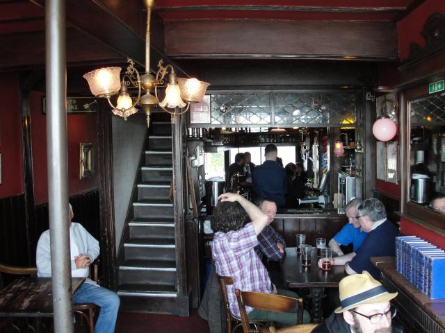 Book 1 Ch. 6: inside The Grapes - "The wood forming the chimney-pieces, beams, partitions, floors and doors of the Six Jolly Fellowship Porters seemed in its old age fraught with confused memories of its youth".