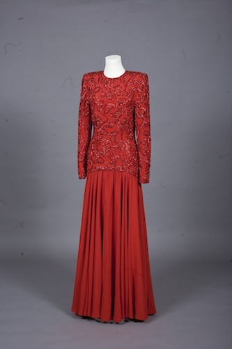 This evening gown by London-based designer Bruce Oldfield is fashionable with its wide shoulders and dropped waist while being modest with long sleeves, a high neckline and full-length skirt making it appropriate for Saudi Arabia, where it was first worn by Princess Diana in 1986. © Linda Sarna and Roberta Hurtig / Historic Royal Palaces / NTI Newsteam