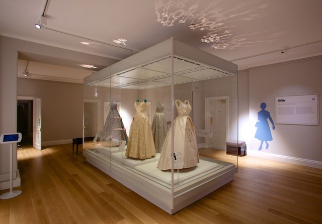 A case of beautiful dresses worn by HM The Queen opens the new Fashion Rules show at Kensington Palace