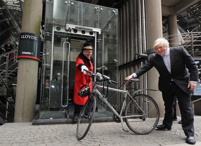 London Mayor Boris Johnson receives his bicycle from Lloyds Waiter David Hughes following a visit to Lloyd's of London as part of his engagement with the City, LLoyds, London PRESS ASSOCIATION Photo. Picture date: Monday June 24, 2013. Photo credit should read: Anthony Devlin/PA Wire