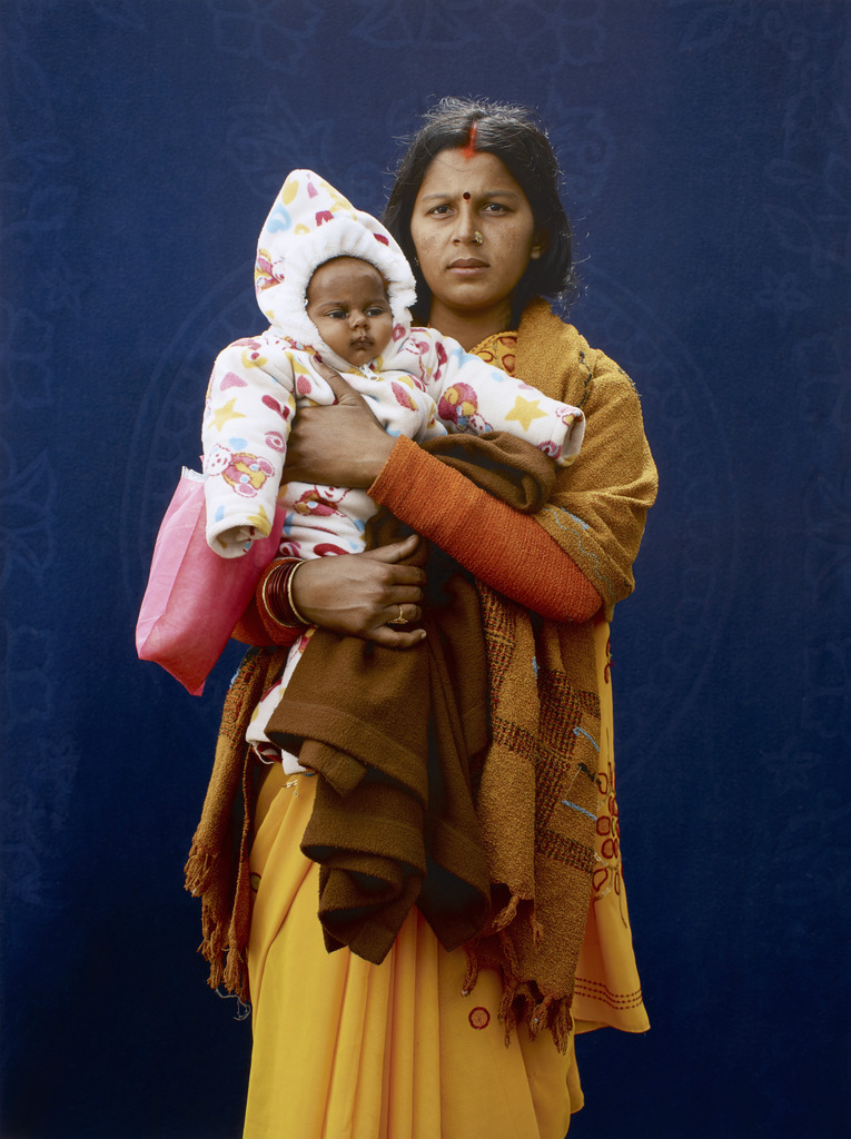 Kumbh Mela Pilgrim - Mamta Dubey and infant by Giles Price, 2013. Copyright Giles Price.