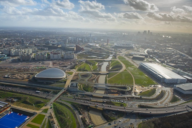 Aerial view of the redevelopment of the Queen Elizabeth Olympic Park looking South with Canary Wharf in the background.