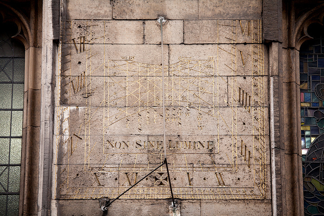 Sun dial on wall in Spitalfields by James Guppy