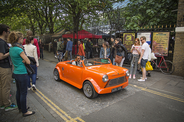 Orange car, by Michael Goldrei 