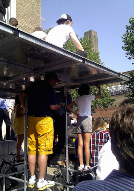 Using a bike shelter as a viewing platform during the Olympic Torch relay. Photo by Dan Brown.