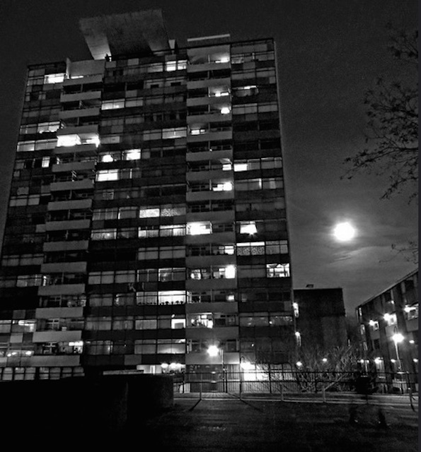 The moon hovers behind the Golden Lane Estate tower block in the City. Photo: EZTD