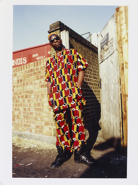 E.110-2012
Photograph
African Homeboy-Brixton, London, 1987; Portrait photograph of a young man standing by a wall wearing colourful African influenced clothes and dark sunglasses.
Normski
;
Brixton
1987
Fujifilm C-type colour print