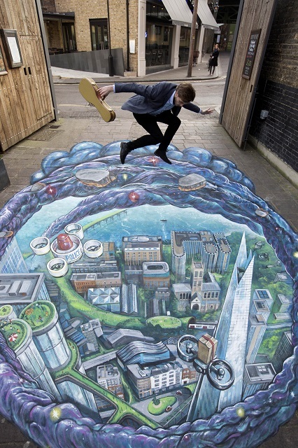 EMBARGOED TO 0001 WEDNESDAY MARCH 11
EDITORIAL USE ONLY
Busker Tom Butler performs on the edge of a piece of 3D artwork called Wormhole to the Future, at Brew Wharf in London, which was created to mark the launch of FutureFest, an initiative of innovation charity, Nesta, which is taking place at Vinopolis, London Bridge on 14th and 15th March. PRESS ASSOCIATION Photo. Picture date: Tuesday March 10, 2015. Photo credit should read: David Parry/PA Wire