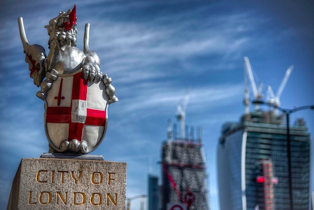 This dragon, and others like it, mark the boundary to the City of London. This one sits at the southern side of London Bridge.  In the background you can see the Walkie Talkie and Cheesegrater both still under construction. Photo: Tonybill (2013)