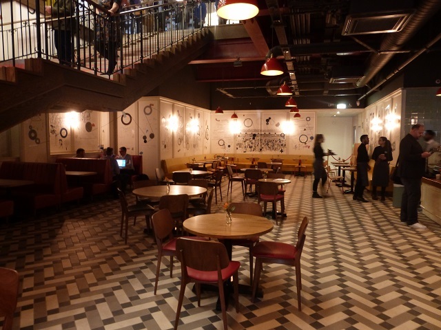 Downstairs a cafe welcomes people with or without a ticket.