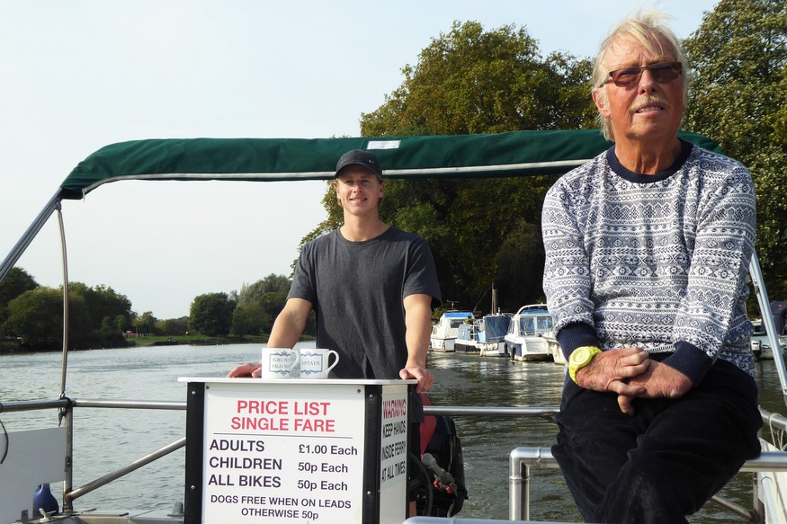 Two men looking at the camera, on board the Hammertons Ferry vessel