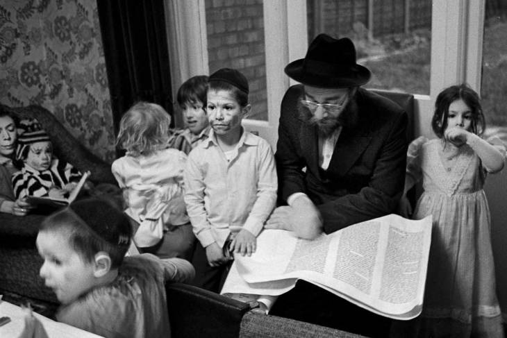 Jewish man reading to children