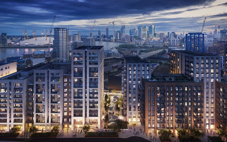 A group of new build apartment blocks stands before a skyline that includes the O2 dome and docklands