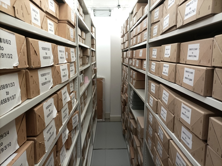 London museums free entry: Stacks of cardboard boxes with documents
