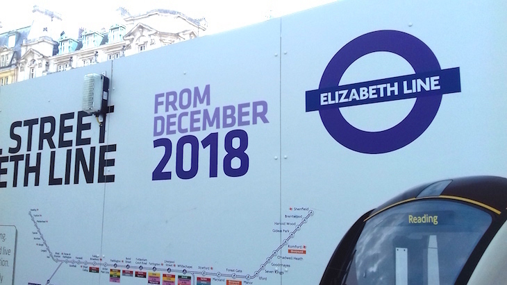 A billboard back in 2018, saying 'Elizabeth line from December 2018', with a map of the Elizabeth line route