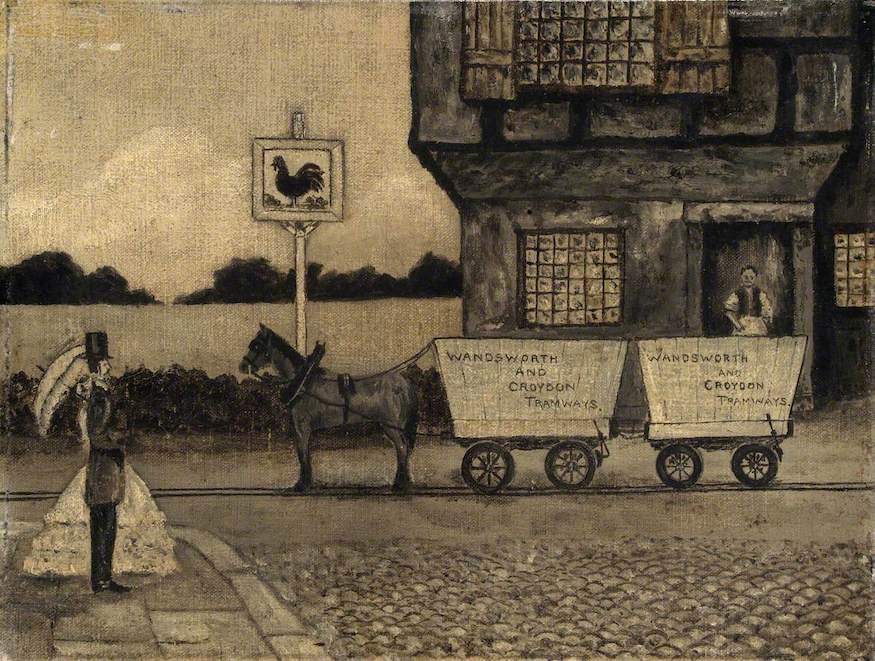 A black and white image of a horse pulling two wagons in front of a pub whose sign is a massive cock.