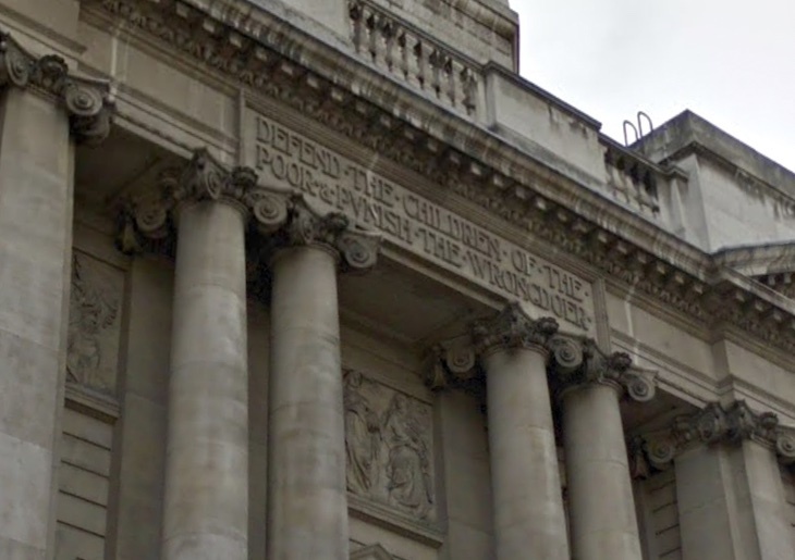 A quartet of ionic columns holds up the message Defend the Children of the Poor & Punish the Wrongdoer