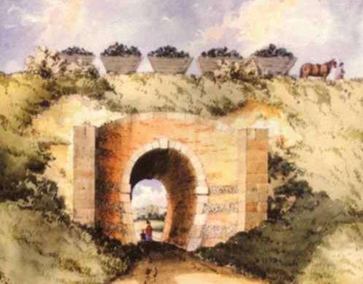 A horse pulls five carriages full of something that looks like coal over a narrow-arched viaduct. It's a watercolour painting and a bit fuzzy.