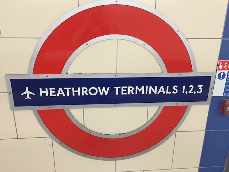 'Heathrow Terminals 1,2 & 3' roundel mounted on a tiled wall in a tube station