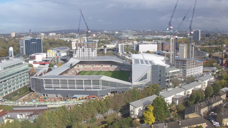 Brentford Community stadium from above, surrounded by cranes