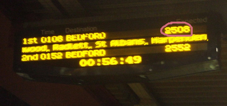 A yellow-on-black train display system shows the times 25:08 and 25:52